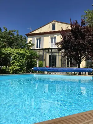 a large swimming pool in front of a building at LaFabriek in Canet d'Aude