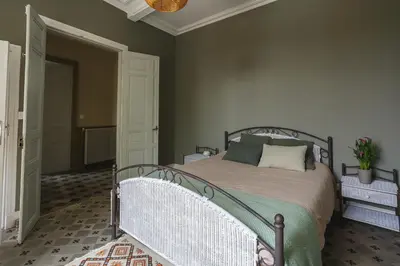 a bedroom with a bed with a metal frame at LaFabriek in Canet d'Aude