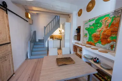 a room with a table and a map on the wall at Chez la fille de l éclusier in Castelnaudary