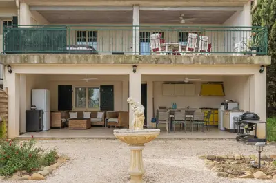 a statue in a fountain in front of a house at Villa les cigales in Ouveillan