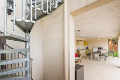 a staircase leading to the kitchen and dining room of a house at Villa les cigales in Ouveillan