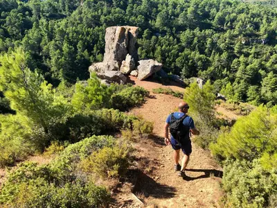 a man walking on a trail on a mountain at Gîtes Corbières in Montséret