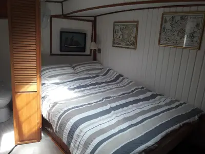 a bed in a bedroom with a striped blanket at Peniche Caroline in Capestang