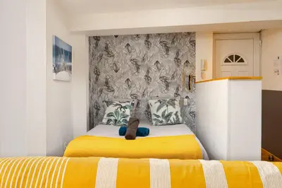 a bedroom with a bed with a teddy bear on it at Le Cathare-Limoux-WIFI-Parking free-Oc-Keys in Limoux