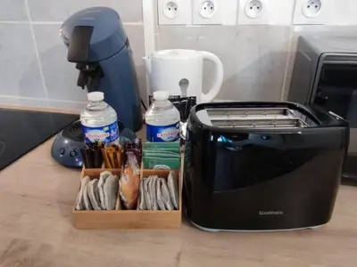 a toaster sitting on a counter next to a box of food at Le Cathare-Limoux-WIFI-Parking free-Oc-Keys in Limoux
