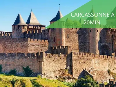 a large castle with a green sign that says car at Le Cathare-Limoux-WIFI-Parking free-Oc-Keys in Limoux