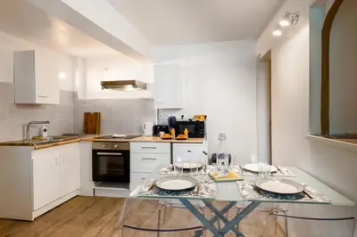 a kitchen with a table with two plates on it at Le Cathare-Limoux-WIFI-Parking free-Oc-Keys in Limoux