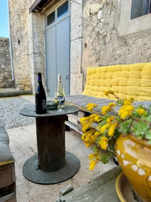 a table with two bottles of wine on top of it at L'Oustal de Papet in Ferrals-lès-Corbières