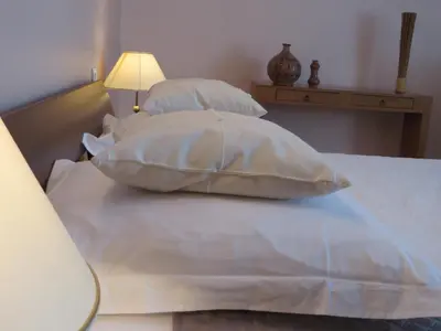 a bed with four pillows and a lamp on it at Demeure vigneronne de charme Pays CATHARE Carcassonne Jacuzzi in Blomac