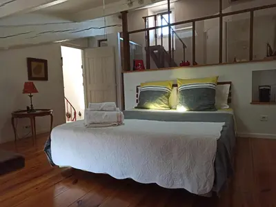 a bedroom with a large bed with white sheets and pillows at Demeure vigneronne de charme Pays CATHARE Carcassonne Jacuzzi in Blomac