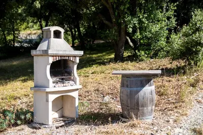 a bird house sitting next to a trash can at Gîtes du Pont de Calmel in Rieussec