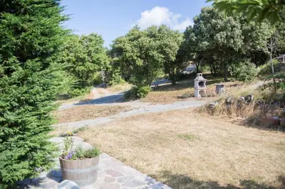 a garden with a grave in the distance at Gîtes du Pont de Calmel in Rieussec