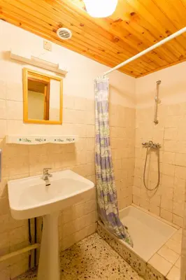 a bathroom with a sink and a shower at Gîtes du Pont de Calmel in Rieussec