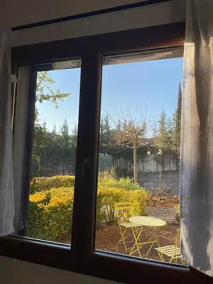 a window with a view of a table and a patio at Coeur de nature in Rasiguères