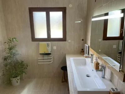a bathroom with a sink and a mirror at Coeur de nature in Rasiguères