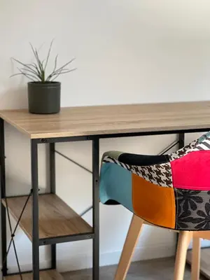 a wooden desk with a chair and a plant at Beau T4 au cœur du centre ville in Narbonne