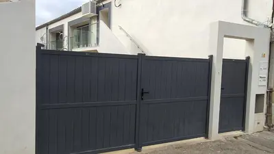 a black gate in front of a house at Beau T4 au cœur du centre ville in Narbonne