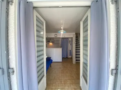 a hallway leading to a kitchen in a house at La Maison Bleue in Gruissan