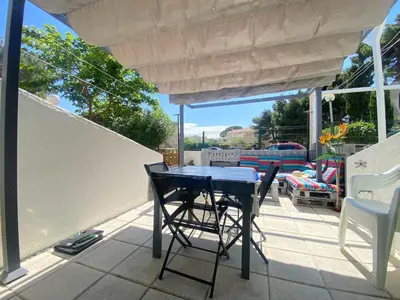 a black table and chairs on a patio at La Maison Bleue in Gruissan