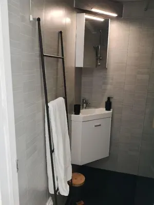 a bathroom with a white sink and a mirror at La Maison Bleue in Gruissan