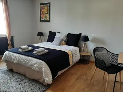 a bedroom with a bed with two towels on it at Chambre double dans maison chaleureuse et familiale in Carcassonne