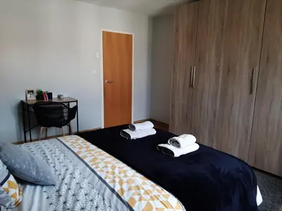 a bedroom with two beds with towels on them at Chambre double dans maison chaleureuse et familiale in Carcassonne
