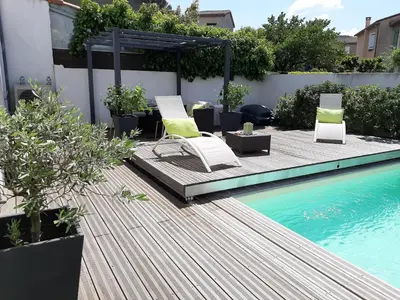 a patio with chairs and a swimming pool at Chambre double dans maison chaleureuse et familiale in Carcassonne