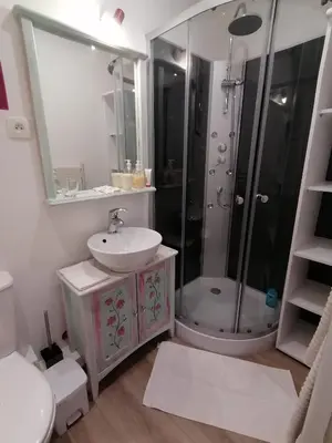 a white bathroom with a sink and a shower at Charmant logis au coeur de Mirepoix in Mirepoix