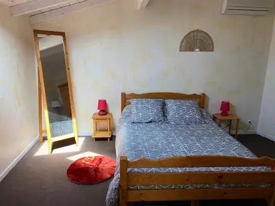 a bedroom with a bed and two lamps and a mirror at Les Plages Haute in Peyriac-de-Mer