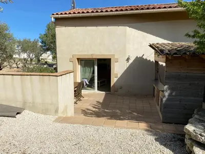 a house with a door open in a yard at Les Plages Haute in Peyriac-de-Mer