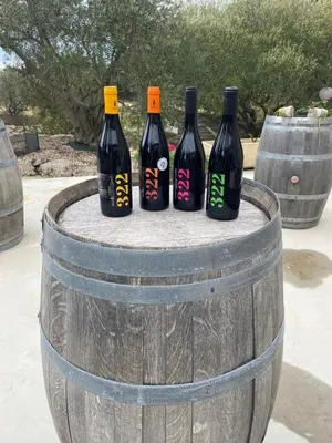 four bottles of wine sitting on top of a barrel at Les Plages Haute in Peyriac-de-Mer
