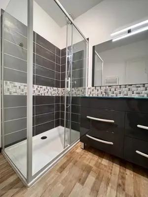 a bathroom with a shower and a glass shower stall at Gorgeous town house in Narbonne