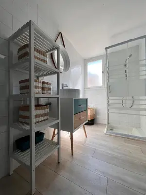 a bathroom with a sink and a desk and a shower at Gorgeous town house in Narbonne
