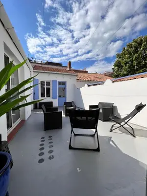 a patio with chairs and chairs on a roof at Gorgeous town house in Narbonne