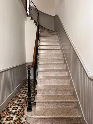 a staircase in a building with a carpet at Gorgeous town house in Narbonne