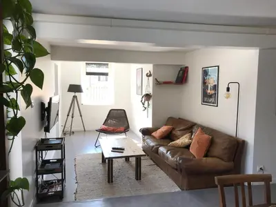 a living room with a couch and a coffee table at Appartement climatisé avec terrasse in Carcassonne