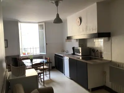a kitchen with a sink and a table in a room at Jolie maison de village à Roquecourbe in Roquecourbe