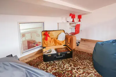 an open suitcase sitting on a rug in a room at HARRY POTTER - Escape Game - Expérience Magique in Carcassonne