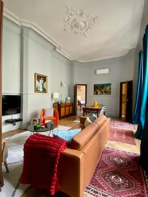 a living room with a couch and a table at Maison ÉGLANTINE Historic 4 star with Air Conditioning in Carcassonne