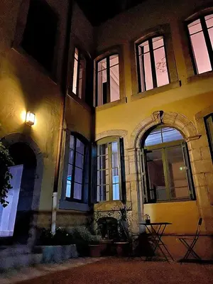 a building with windows at night at Maison ÉGLANTINE Historic 4 star with Air Conditioning in Carcassonne