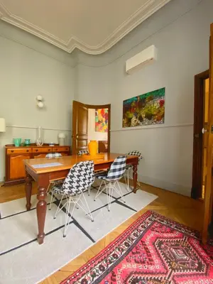 a dining room with a wooden table and chairs at Maison ÉGLANTINE Historic 4 star with Air Conditioning in Carcassonne