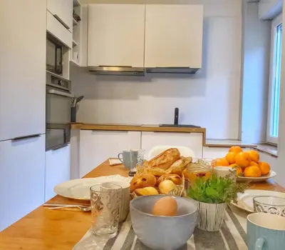 a kitchen table with a plate of bread and eggs at 3 Star 3 bed Air Conditioned QUERTINEUX 100m to Historic 4 Cathar Châteaux Lastours access to a very Pretty Riverside Garden!! in Lastours