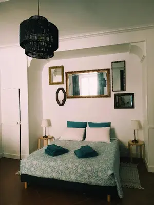 a bedroom with a bed with two pillows on it at Le 9 de Cour, Chambre Caouette in Carcassonne