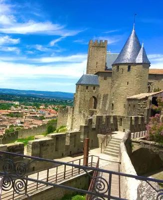 a large castle with stairs leading up to it at Bijou SURDESPINE air conditioned 100m to Historic 4 Cathar Châteaux Lastours access to a very pretty riverside garden!! in Lastours