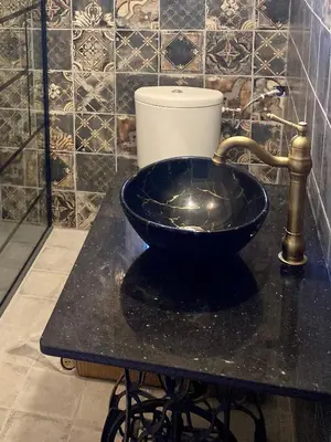 a bathroom with a sink and a toilet on a counter at CheRiedel Bed & Breakfast & Art Gallery in Azillanet