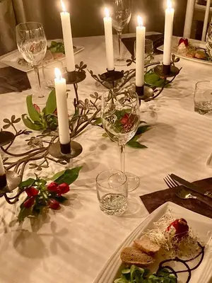 a table with candles and plates of food on it at CheRiedel Bed & Breakfast & Art Gallery in Azillanet