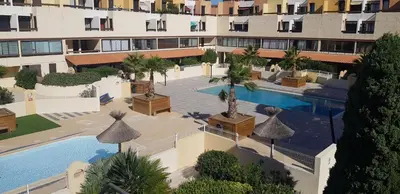 an aerial view of a hotel with a swimming pool at Gruissan-Port-T3-2chambres-5pers-43m2-Parking-Clim-Piscine-Valerie in Gruissan