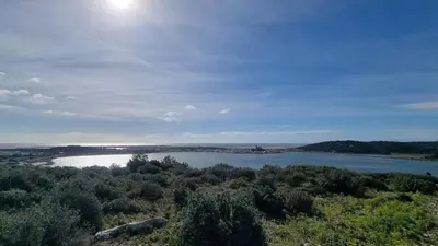 a view of a lake with the sun in the sky at Gruissan-Port-T3-2chambres-5pers-43m2-Parking-Clim-Piscine-Valerie in Gruissan