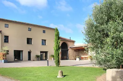 a large building with a yard in front of it at Domaine des Marronniers in Tourtrol