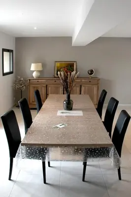 a dining room with a table and chairs at Domaine des Marronniers in Tourtrol